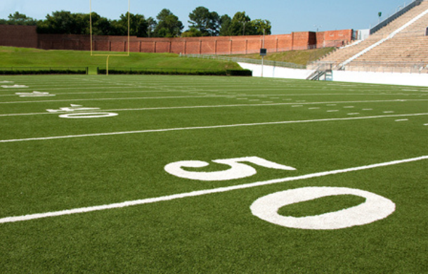 An American Football field looking from the mid zone downfield to the end zone.
