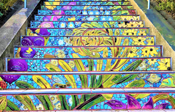 A set stairs adorned with mosaic art of flowers.